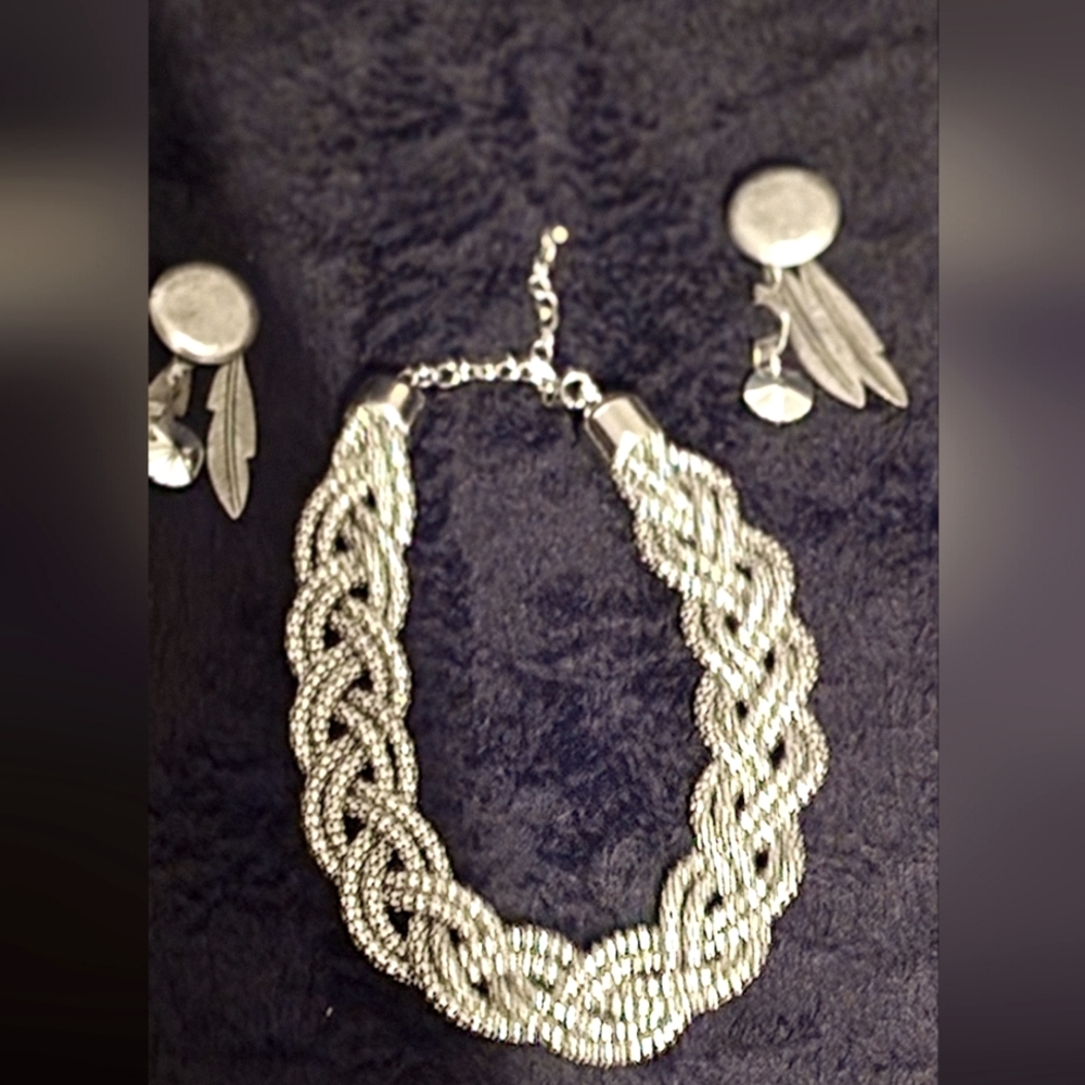 A silver rope necklace with earrings